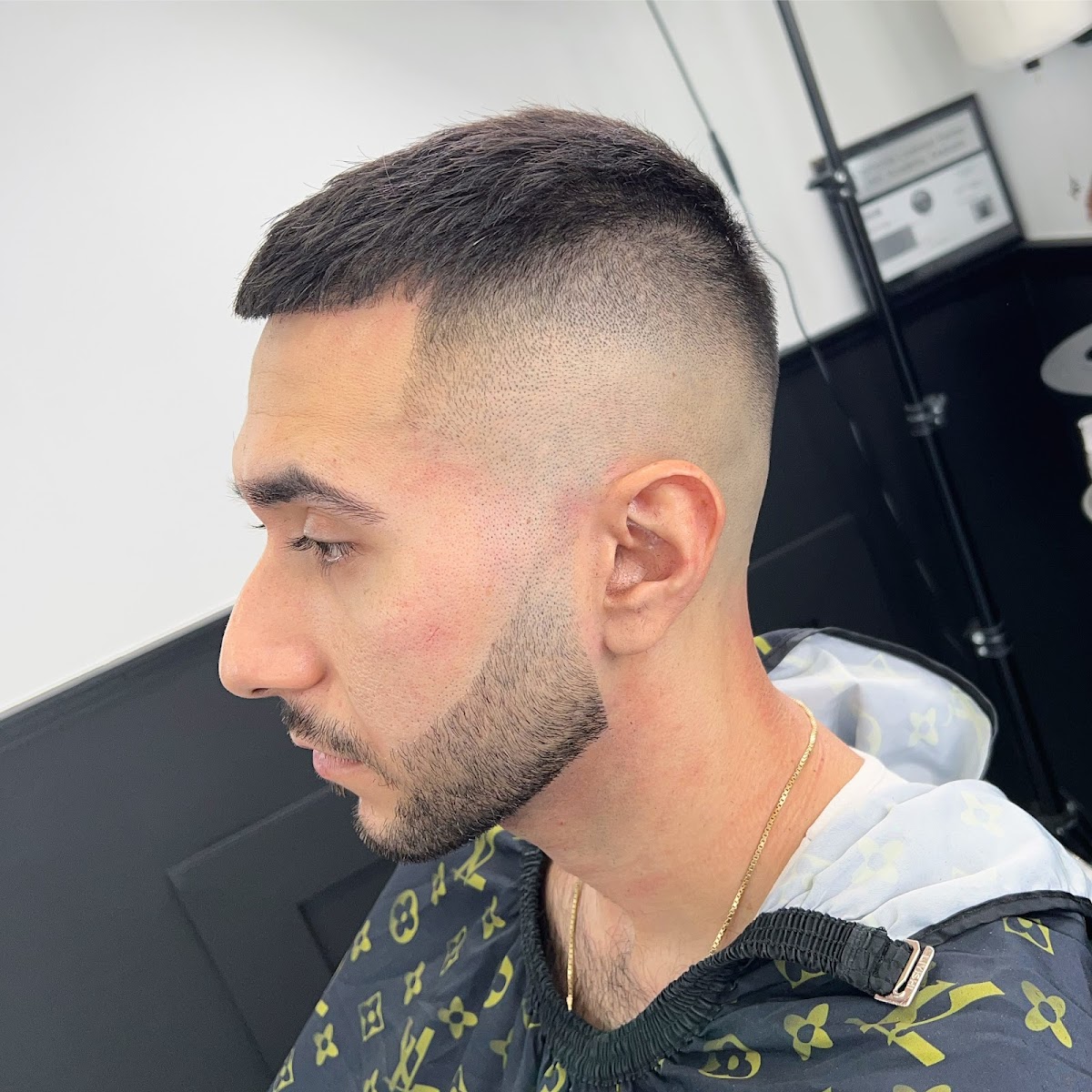 Crisp high skin fade with light beard work