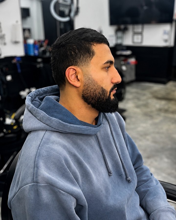 Buzz cut and full beard with hooded sweater