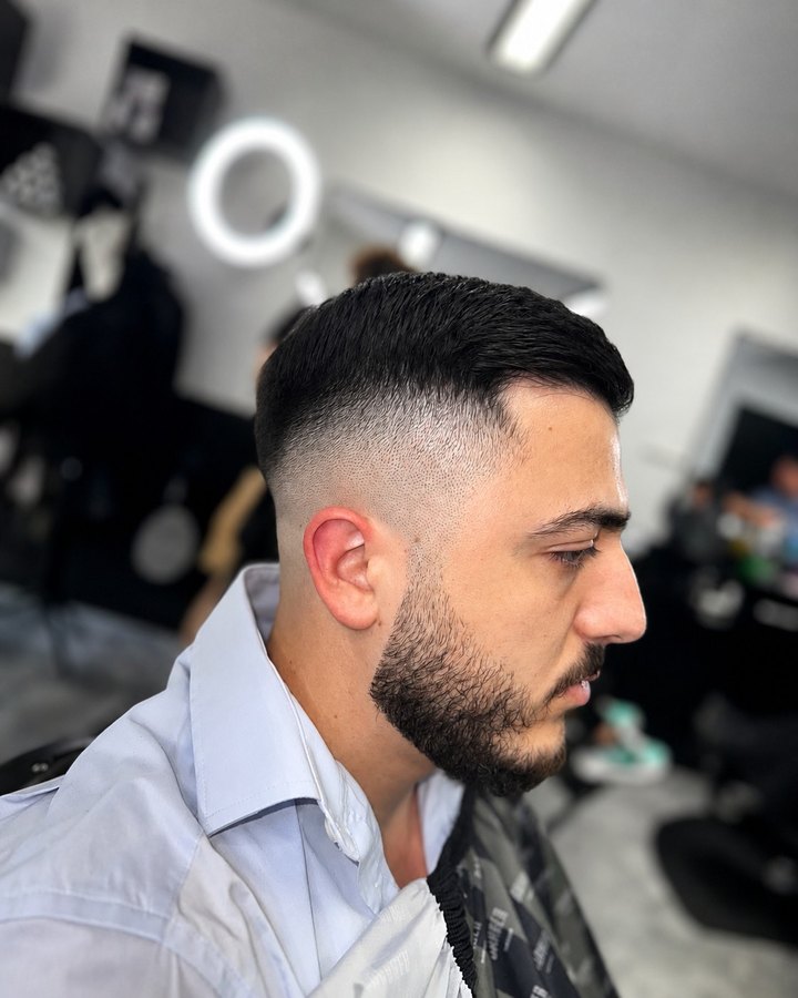 Classic side-part with skin fade and trimmed beard